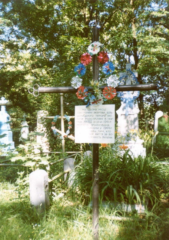 Номер фотографии 1 : Крест на месте захоронения жертв расстрелов в июне 1941 г. : кладбище : фотограф И. Федущак